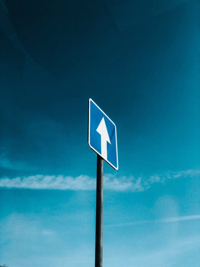 road sign standing against a blue sky