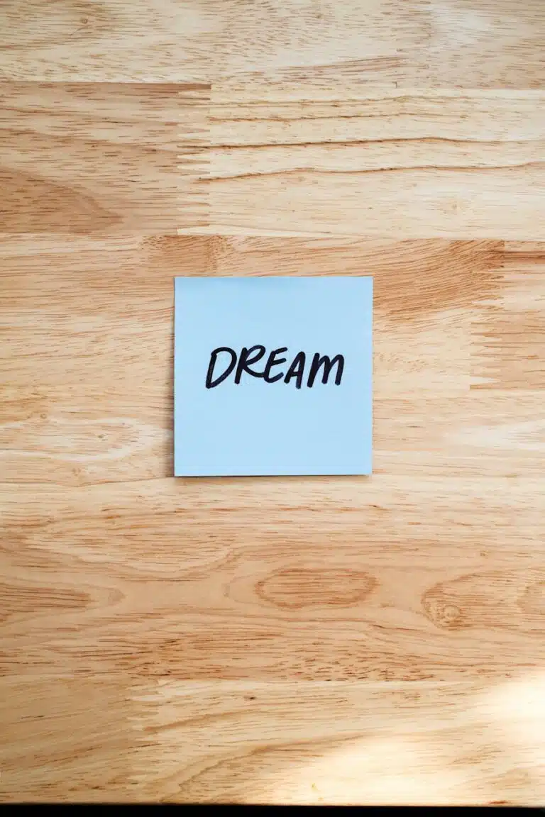 dream motivation note on wooden background