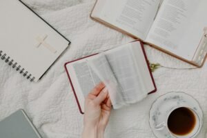 person holding white book page
