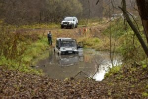 vehicles driving in a puddle
