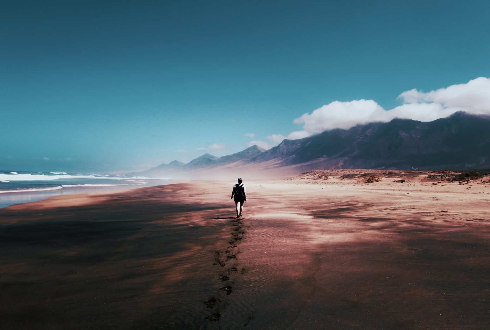 photo of person walking on deserted island