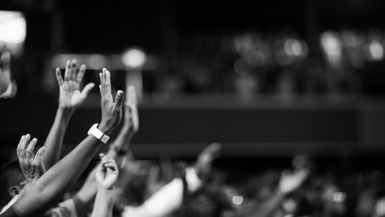 grayscale photography of hands waving