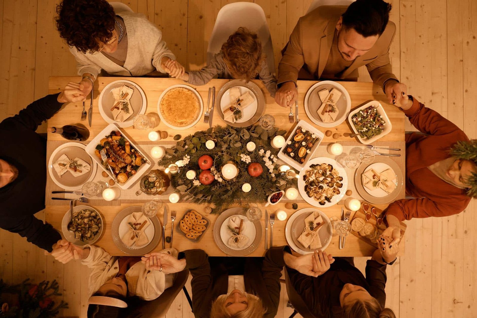 top view of a family praying before christmas dinner