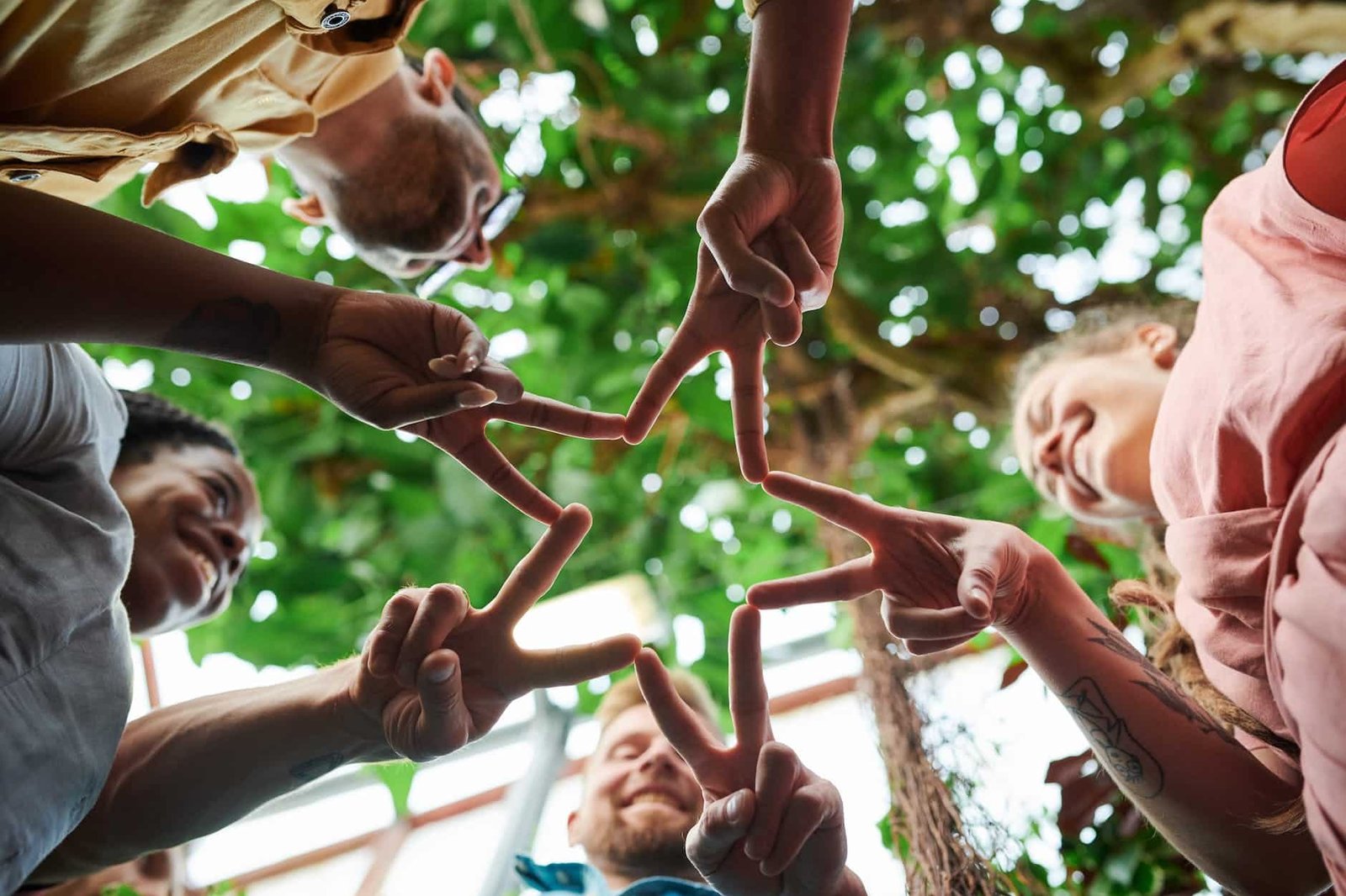 low angle photography of people s finger doing star shape