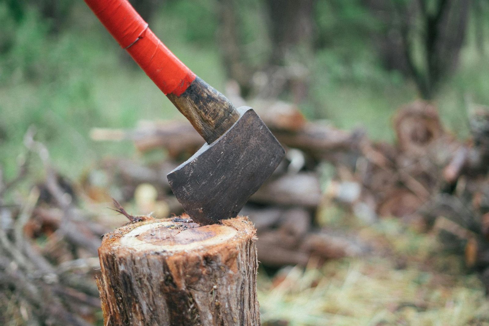 photo of axe on wooden log