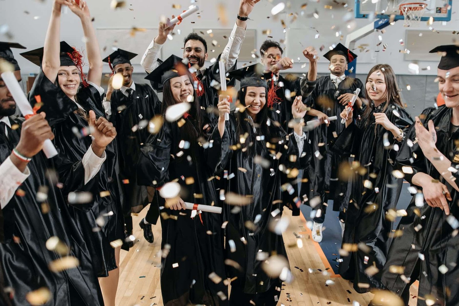 photo of fresh graduates celebrating in gym