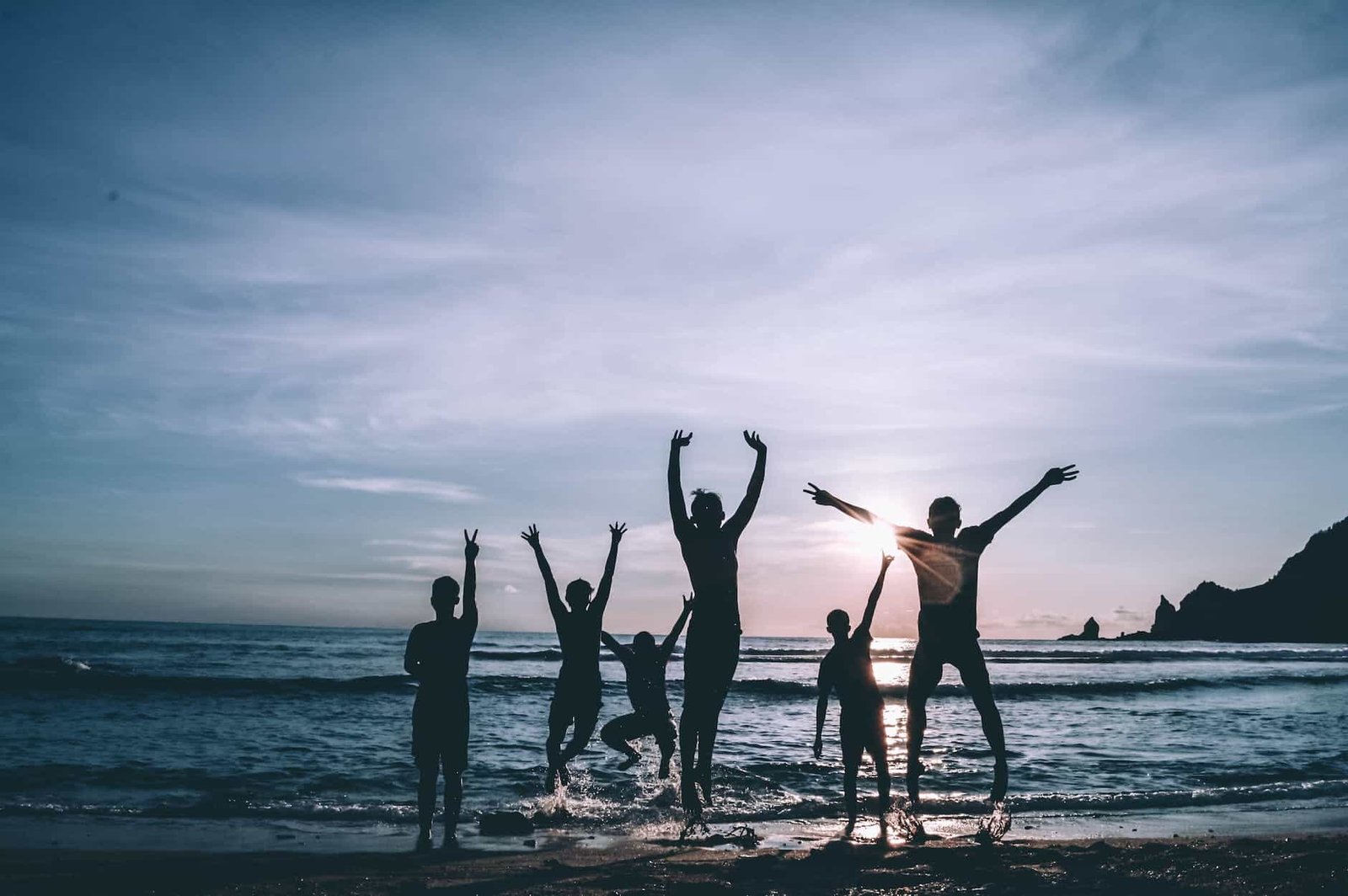 silhouette of people by the seashore