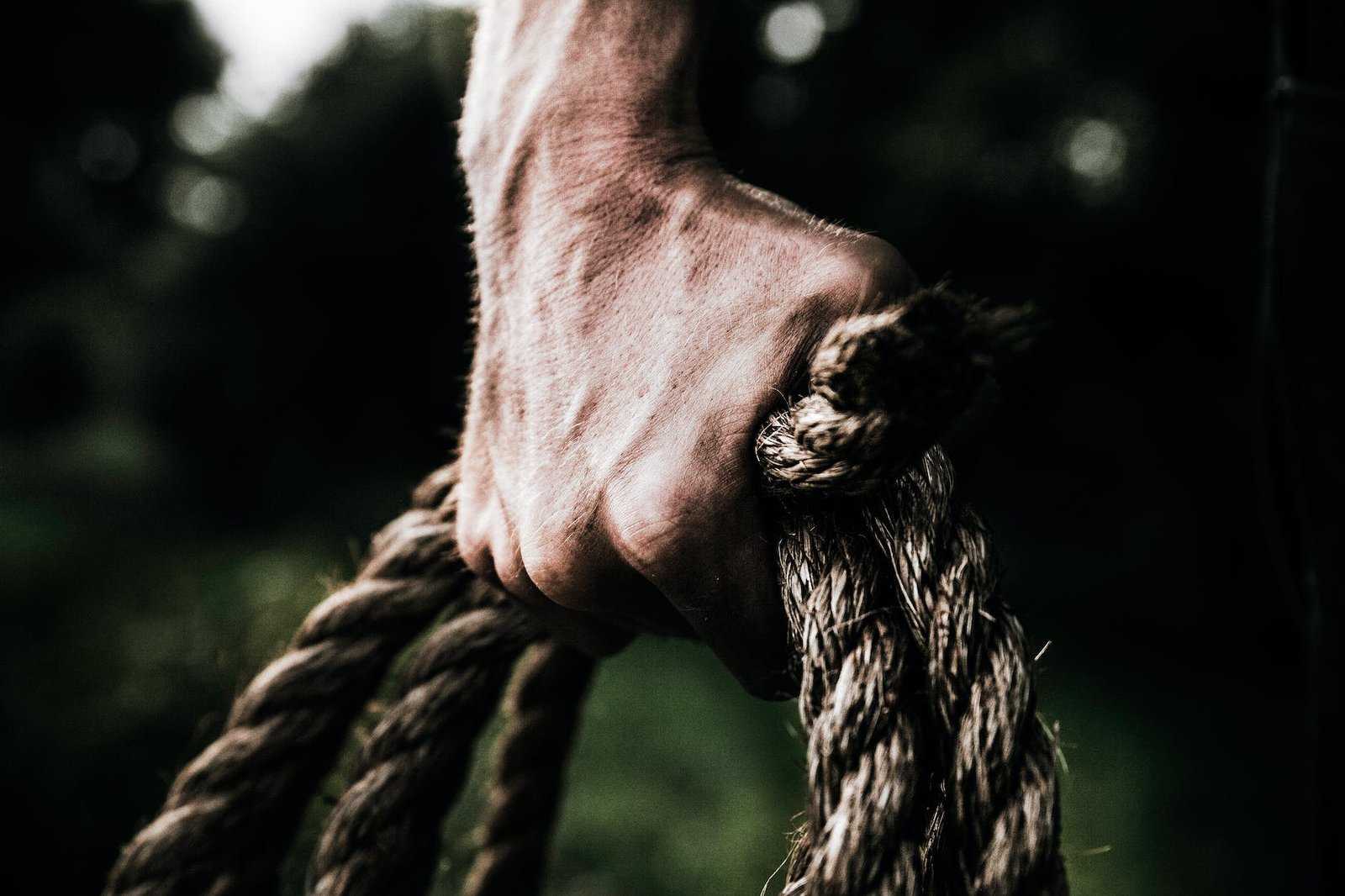 man holding brown rope