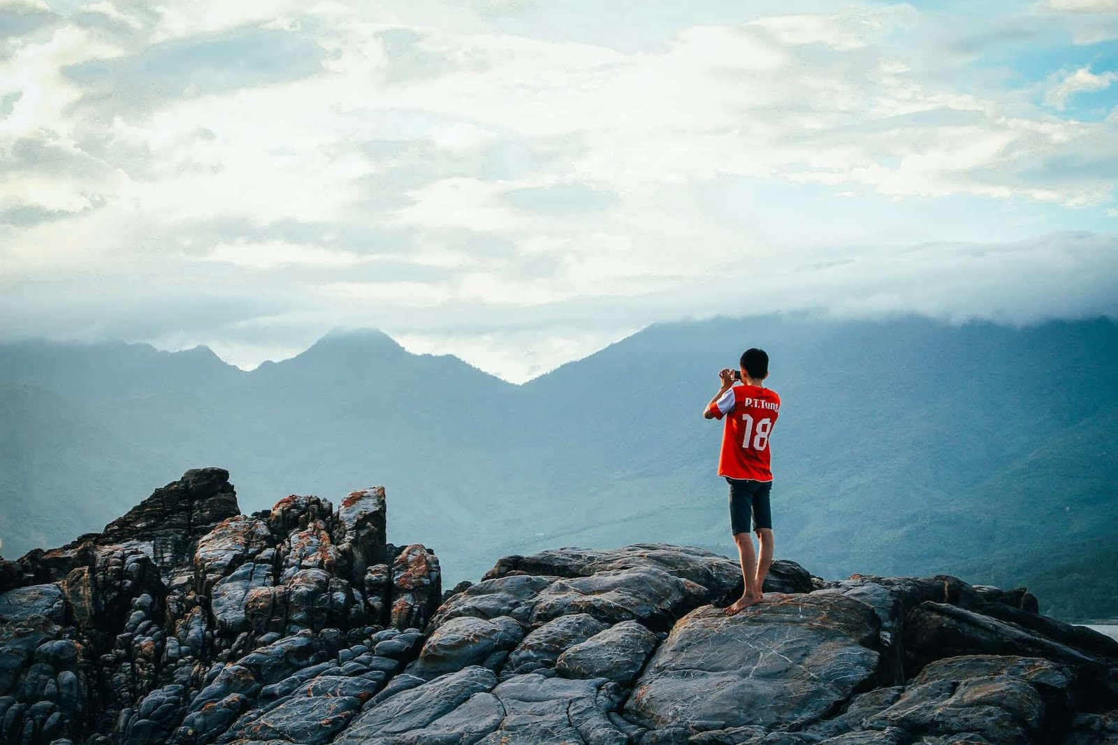 man having a picture on rock