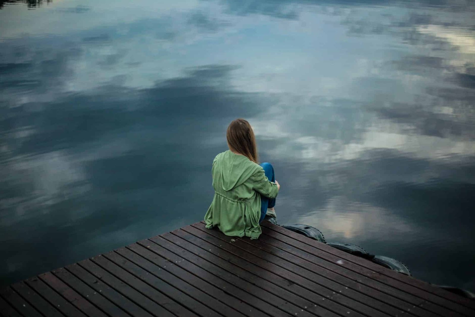 woman sitting on wooden planks