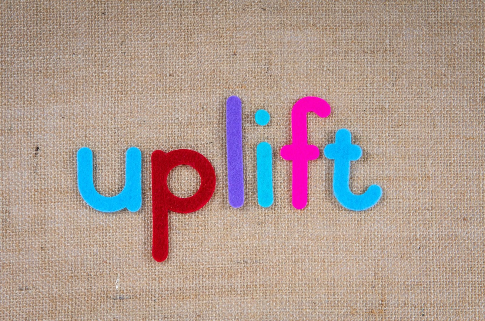 the word uplift on a woven surface