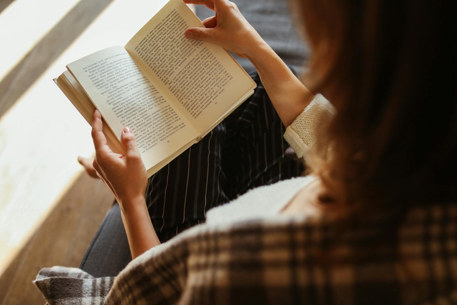 close up of woman reading book