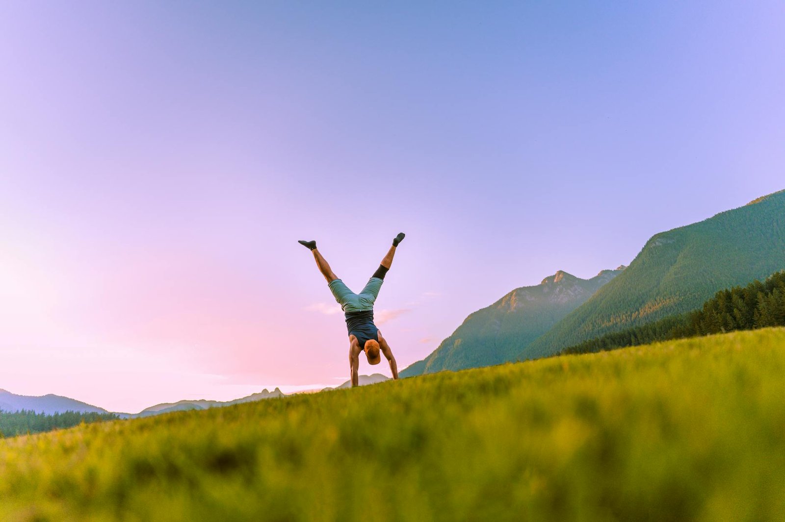 a man doing a handstand under a clear blue sky