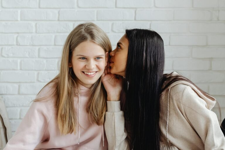 young women in pink sweater having a conversation