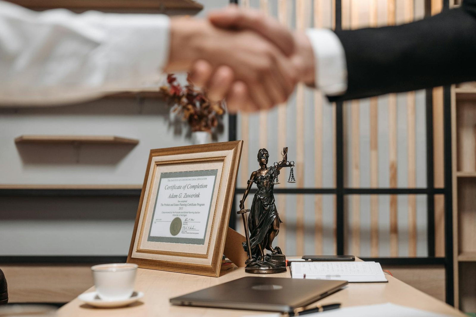 people shaking hands at lawyers office