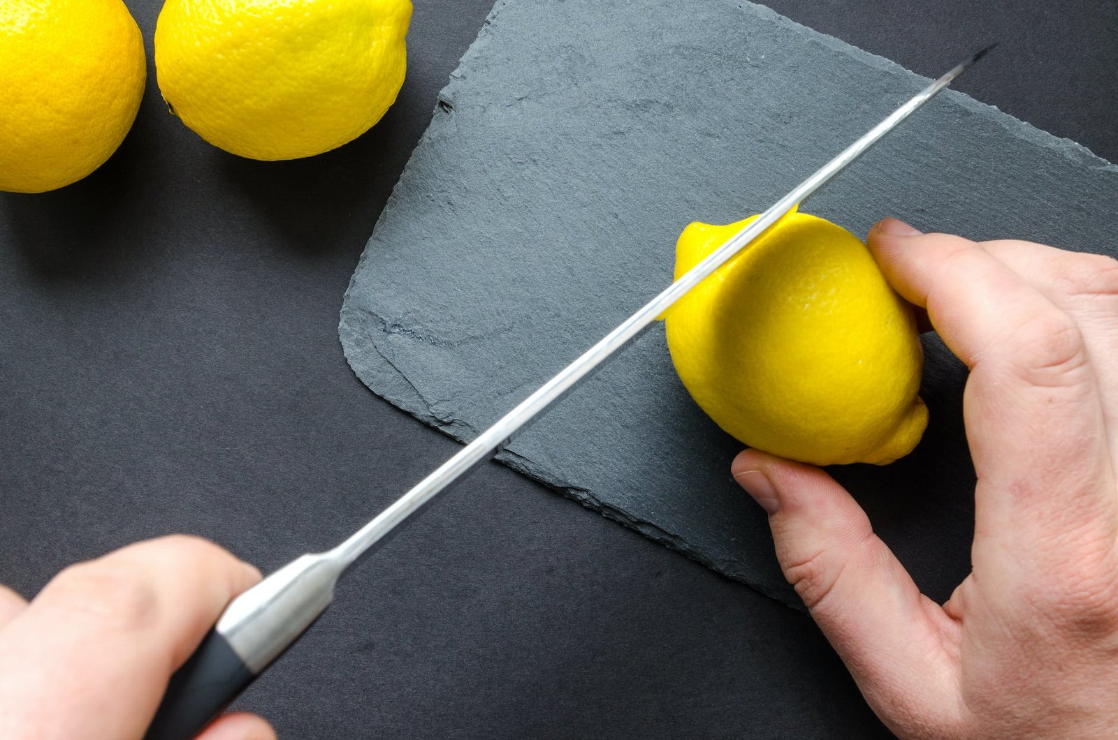 photo of person slicing lemon