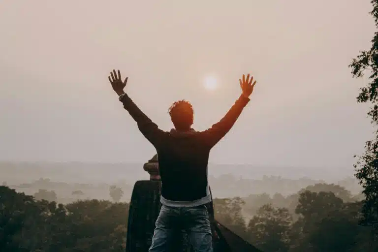 a man raising his arms