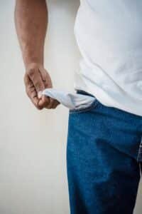 person in blue denim jeans holding white textile