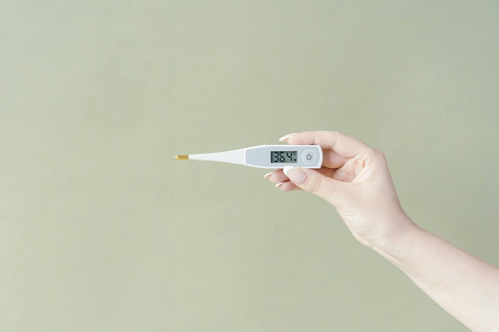 close up shot of a person holding a thermometer