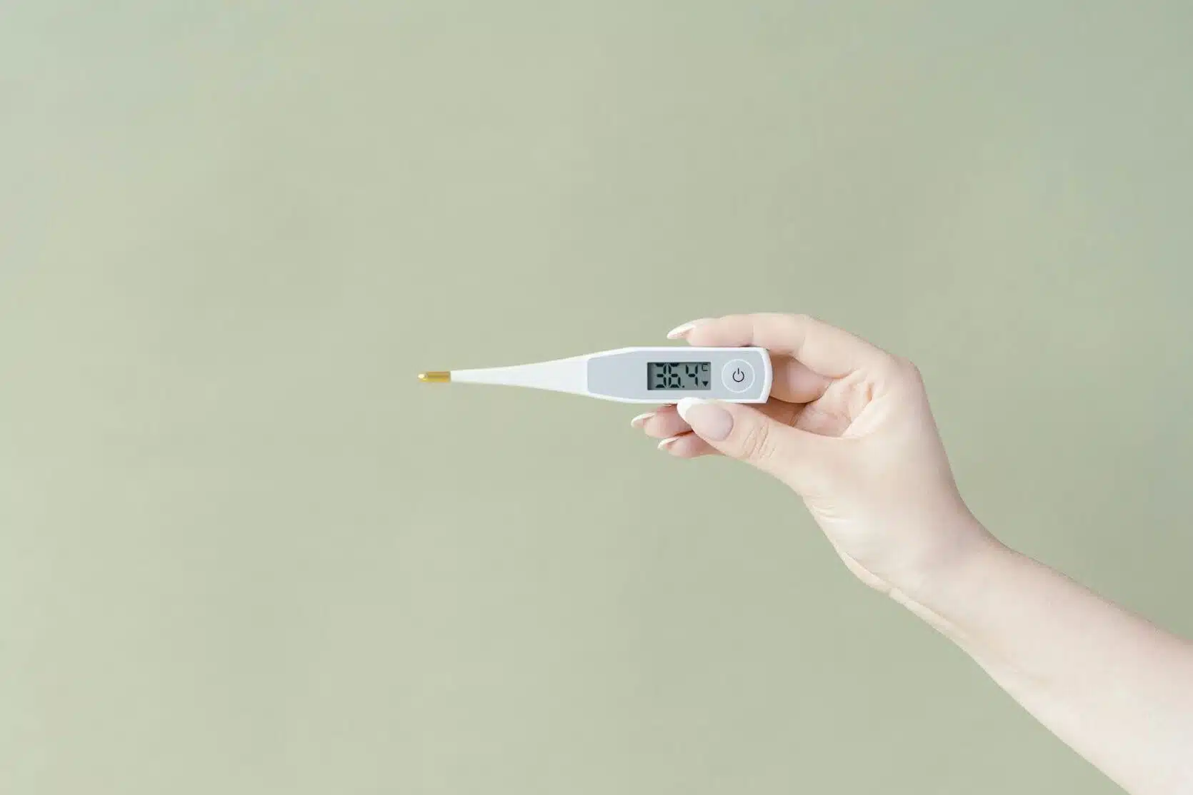 close up shot of a person holding a thermometer